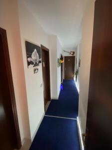 un corridoio con pavimenti in moquette blu in un edificio di Colomba Bianca a Marsala