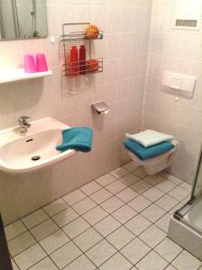 a bathroom with a sink and a toilet at Appartementhaus Panny in Bad Füssing