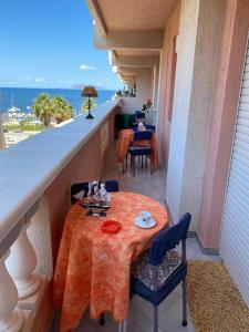 a balcony with a table and chairs and the ocean at Colomba Bianca in Marsala