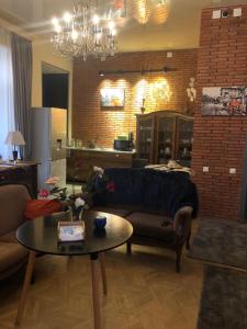 Brickwall Tbilisi-Tbilisi vibe في تبليسي: غرفة معيشة مع أريكة وطاولة