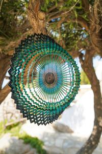 a peacock decoration hanging from a tree at Baba Houlakia in Houlakia