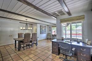 a kitchen and dining room with a table and chairs at Phoenix Getaway with Private Pool and Grass Yard! in Phoenix