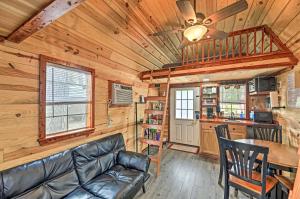 a living room with a couch and a table in a cabin at The Gosling Studio Cabin with River Access! in New Bern