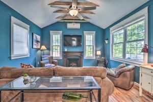 a living room with a couch and a fireplace at Peaceful Virginia Cabin - Fish, Tube, Boat, Etc! in Edinburg