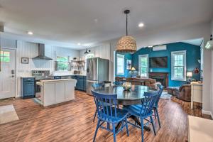 a kitchen and living room with a table and chairs at Peaceful Virginia Cabin - Fish, Tube, Boat, Etc! in Edinburg