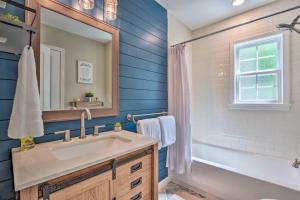 a bathroom with a sink and a tub and a mirror at Peaceful Virginia Cabin - Fish, Tube, Boat, Etc! in Edinburg +27 photos