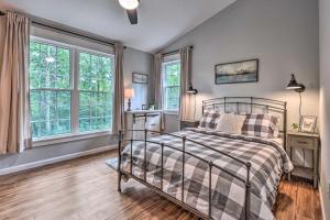 a bedroom with a bed and two windows at Peaceful Virginia Cabin - Fish, Tube, Boat, Etc! in Edinburg