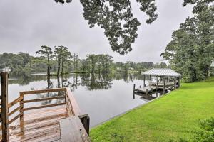 a dock on a lake with a gazebo at Cottage with Patio and Shared Waterfront Perks! in New Bern