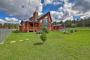 a wooden house on a green field with a tree at Woodsy Pinetop Oasis, 11 Mi to Rainbow Lake! in Pinetop-Lakeside