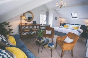 a living room with a bed and a couch at Bayards Cove Inn in Dartmouth