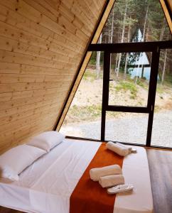 a bed in a tent with two towels on it at Surami Savannah სურამი სავანა in Surami