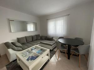 a living room with a couch and a table at Tole Villa Podaca in Podaca +21 photos
