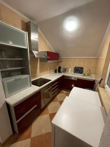 a kitchen with a refrigerator and a table in it at Tole Villa Podaca 2 with heated Pool in Podaca