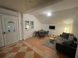 a living room with a couch and a table at Tole Villa Podaca 2 with heated Pool in Podaca