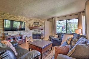 a living room with leather furniture and a fireplace at Slopeside Condo with Hot Tub and Game Room Access! in Brian Head