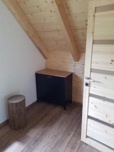 an attic room with a desk and a door at Roubenka Strmá in Jeseník