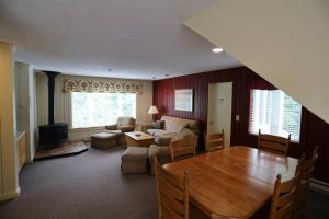 a living room with a table and a couch at Inns Of Wv 301, 2bd, Waterville Valley in Waterville Valley