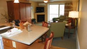 a kitchen and living room with a table and chairs at Inns Of Wv 301, 2bd, Waterville Valley in Waterville Valley