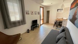 a living room with a couch and a kitchen at Casa Stella in Favignana