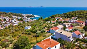 an aerial view of a village on a hill with the ocean at Despoina Apartment in Patitiri