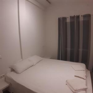 A bed or beds in a room at Dimitra apartments koroni