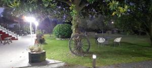 an old wagon wheel sitting in a park at night at Apartamentos la Higar in La Pesa