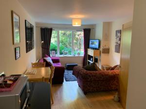 a living room with a couch and a table at Minster View Apartment at Talbot Court, York in York