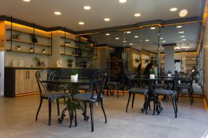 a dining room with tables and chairs in a restaurant at L'opera Deluxe Hotel in Akçay