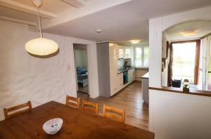 comedor y cocina con mesa y sillas en Cozy apartment close to Zurich Airport and City, en Oberglatt