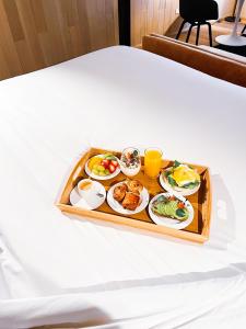a tray of food on a table at Hotel Magnolia Santiago in Santiago