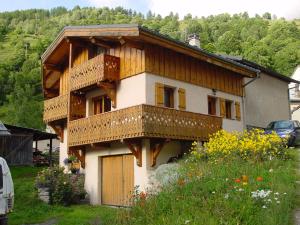 a house with a balcony on the side of it at Chalet Philippe in Peisey-Nancroix