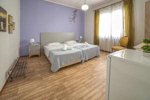 a bedroom with a bed with white sheets and pillows at Aurora in Kavala