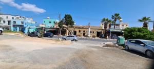 a city street with cars parked on the side of the road at Latchi Area Apartments in Lachi