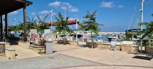 a marina with a clock on the side of it at Latchi Area Apartments in Lachi