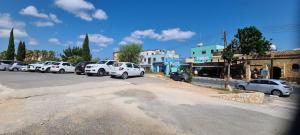 a group of cars parked in a parking lot at Latchi Area Apartments in Lachi