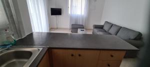 a kitchen with a counter top and a couch at Latchi Area Apartments in Lachi +37 photos