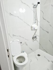 a white bathroom with a toilet and a shower at Latchi Area Apartments in Lachi