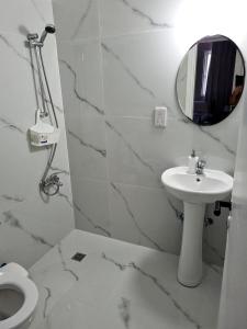 a white bathroom with a sink and a mirror at Latchi Area Apartments in Lachi
