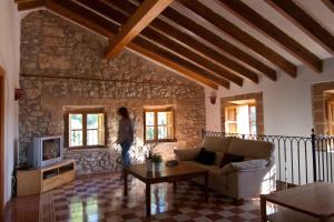 a living room with a couch and a tv at Petit Hotel Hostatgeria La Victoria in Alcudia