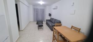 a living room with a couch and a table at Latchi Area Apartments in Lachi
