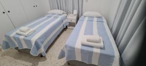 two beds sitting next to each other in a room at Latchi Area Apartments in Lachi