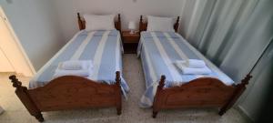 two beds sitting next to each other in a room at Latchi Area Apartments in Lachi
