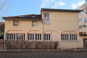 a house with a fence in front of it at La Menuiserie in Gap