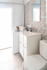 a bathroom with a toilet and a sink at BlueSky Ultra-Central Premium Apartment in Oradea +13 photos