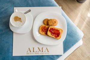 a plate of food with bread and a cup of coffee at ALMA Bed & Breakfast in San Marco Argentano