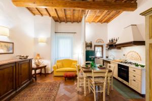 a kitchen with a table and a yellow chair at Fiesole's cozy Apartment 2 in Fiesole
