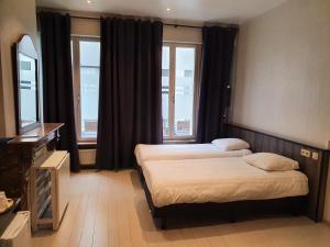 A bed or beds in a room at Albert - Rooms