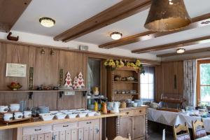 a kitchen with wooden walls and a table with a tableablish at Hotel AlpenSonne Ruhpolding Chiemgau Karte in Ruhpolding