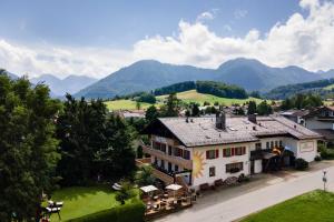 an aerial view of a house with mountains in the background at Hotel AlpenSonne Ruhpolding Chiemgau Karte in Ruhpolding
