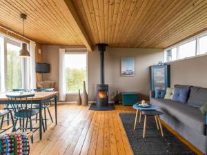 een woonkamer met een bank, een tafel en een open haard bij Holiday home Fanø CXC in Fanø